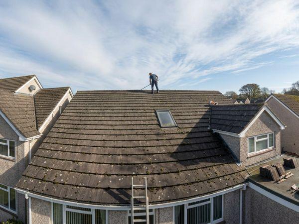 Roof cleaning in progress